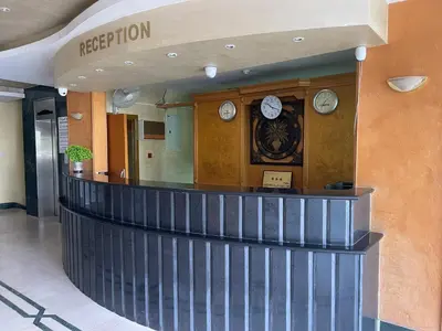a lobby with clocks on the wall and a reception counter at Dweik Rooftop in Aqaba