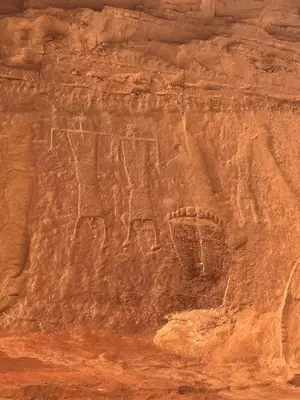 a rock wall with an animal painted on it at Wadi Rum Khalifa Camp in Wadi Rum