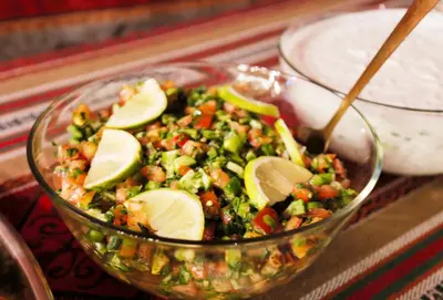 a salad with avocado and vegetables in a glass bowl at Plaza View Hostel in Taiyiba