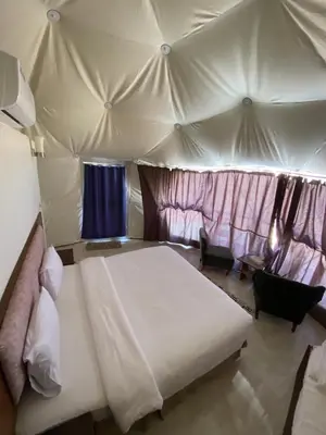 a bedroom with a bed in a tent at Rum Serena Camp in Wadi Rum