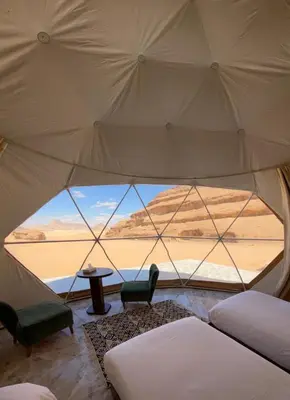 a room with a view of the desert from inside a tent at Rum Serena Camp in Wadi Rum