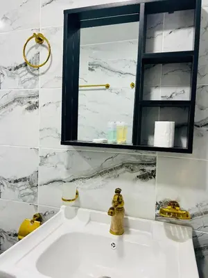 a white bathroom with a sink and a mirror at Arjowana Luxury Camp & Bubbles Hotel in Wadi Rum