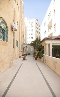 an empty street in a city with buildings at Hanan Residence 01 - 3BR, Der Ghbar 165m2 in Amman