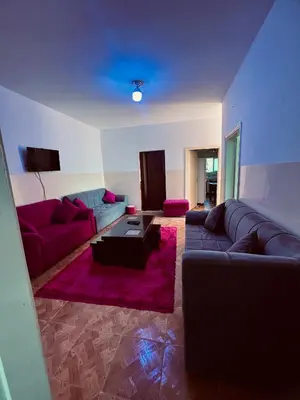 a living room with a couch and a table at Petra Gold Inn Apartments in Wadi Musa
