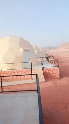 a row of benches sitting in the desert at Nafa Rum Camp in Wadi Rum