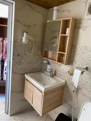 a bathroom with a sink and a mirror at Nafa Rum Camp in Wadi Rum