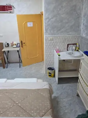 a bathroom with a sink and a yellow door at hostel ـ Karak dream in Kerak