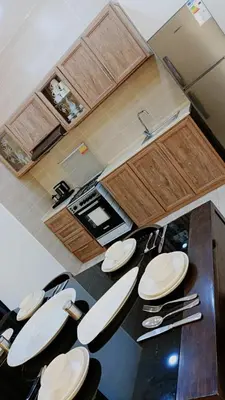 a kitchen with a table with white plates on it at lacasa chalet private With a panoramic view of the DeadSea in Sowayma