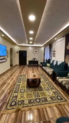 a large living room with a couch and a table at Ad Deir Guesthouse in Wadi Musa