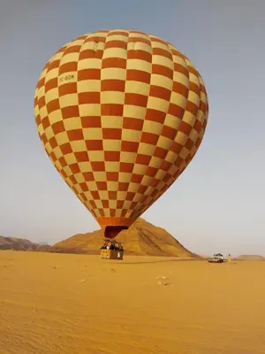 a hot air balloon flying over the desert at Youssef camp Wadi Rum in Wadi Rum