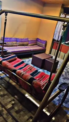 a bed in a room with a couch in the background at Alreem Farm in Ajloun
