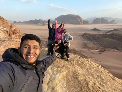 a group of people standing on a rock in the desert at Bedouin experiences in Aqaba