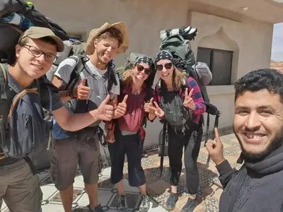 a group of hikers giving the thumbs up sign at Bedouin experiences in Aqaba