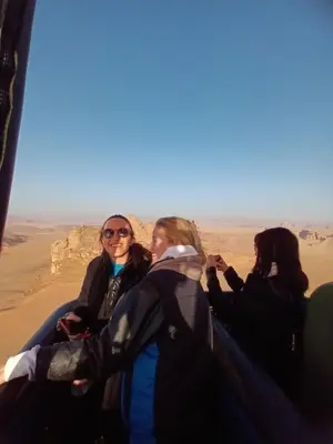 a group of women sitting in the desert at Wadi rum Wild life camp in Wadi Rum