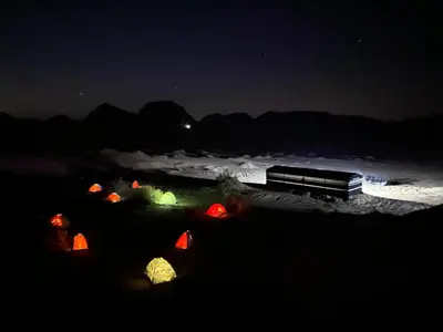a train is parked in a field at night at Wadi rum Wild life camp in Wadi Rum