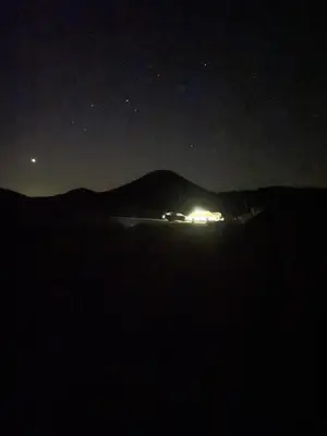 a night time view of a house with lights on at Wadi rum Wild life camp in Wadi Rum