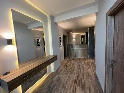 a hallway with a large mirror on the wall at Caprios motel in Al Qasţal