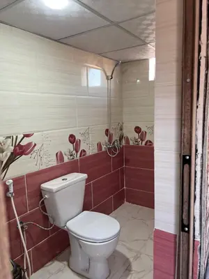 a bathroom with a white toilet in a room at Wadi Rum Cream in Wadi Rum