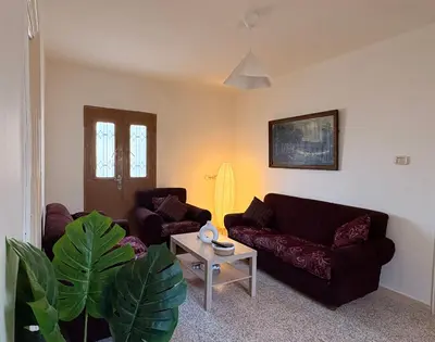 a living room with two couches and a table at Madaba Hills Apt in Madaba