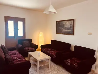a living room with two couches and a table at Madaba Hills Apt in Madaba