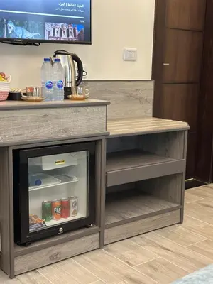 a kitchen with a counter with a refrigerator at La Vie Boutique Hotel in Wadi Musa