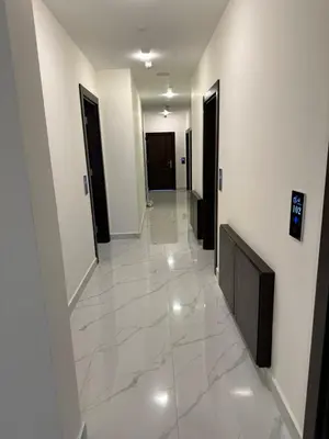 a hallway with white tile floors and black doors at La Vie Boutique Hotel in Wadi Musa