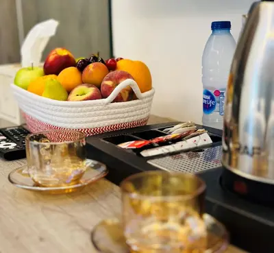 a basket of fruit on a counter with a bottle of water at La Vie Boutique Hotel in Wadi Musa