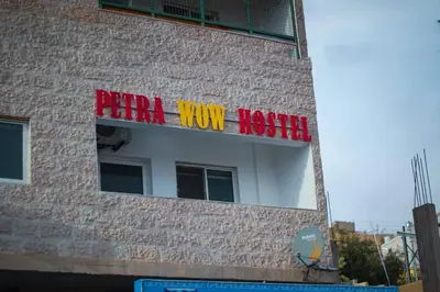 a sign on the side of a building that reads afraid view reality at Petra Wow Hostel in Wadi Musa