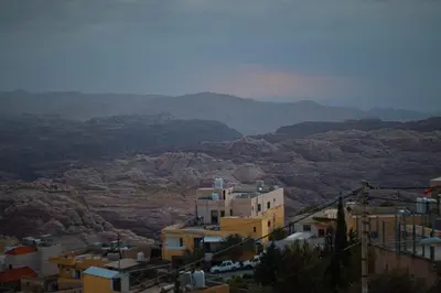 a view of a city with mountains in the background at Petra Wow Hostel in Wadi Musa