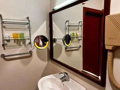 a bathroom with a mirror and a sink at Twilight Hotel Petra in Wadi Musa