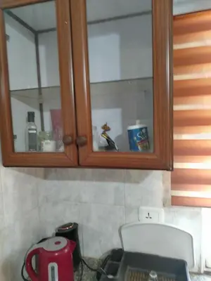 a cabinet in a kitchen with a sink at شقه مفروشة الجبيهه in Amman