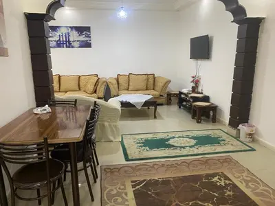 a living room with a table and a couch at شقه مفروشة الجبيهه in Amman