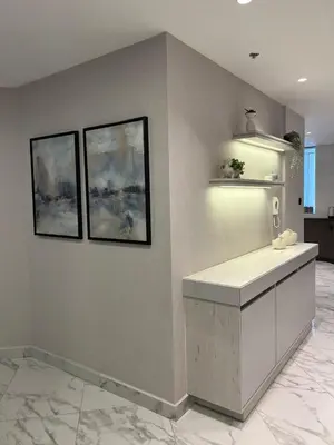 a kitchen with two paintings on the wall and a counter at Downtown pearl Amman in Amman