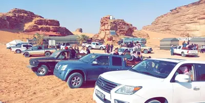 a group of cars parked in the desert at blueskyrum. in Wadi Rum
