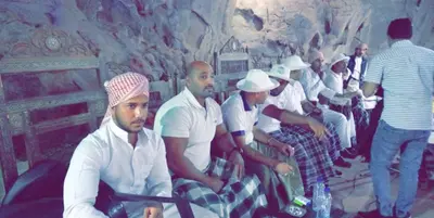 a group of men sitting in a room at blueskyrum. in Wadi Rum