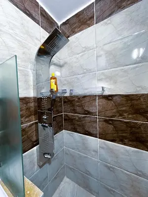 a bathroom with a shower with a glass door at Panorama Jerash HOTEL (2) in Jerash