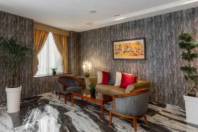 a living room with a couch and a chair at Amman Inn Boutique Hotel in Amman