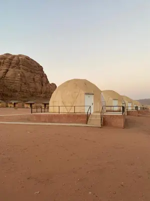 a group of domes in the middle of the desert at Yara camp in Wadi Rum
