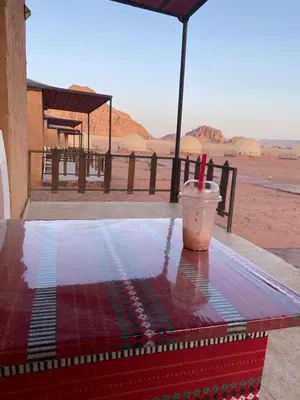 a table with a drink sitting on top at Yara camp in Wadi Rum