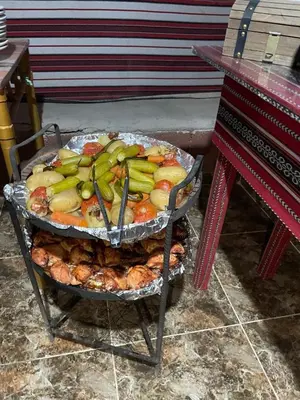 a tray of fruit and vegetables on a grill at Yara camp in Wadi Rum