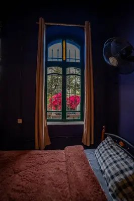 a bedroom with a window with pink flowers at Central house with beautiful garden in Amman