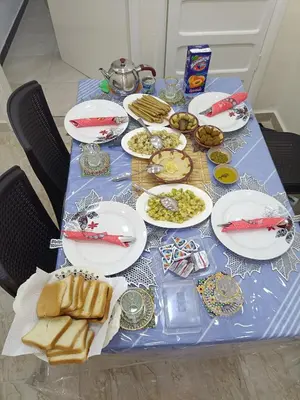 a blue table with plates of food on it at Petra downtown house in Wadi Musa