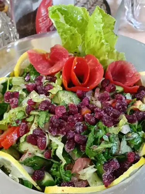 a salad in a white bowl on a table at Petra downtown house in Wadi Musa