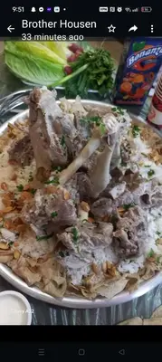a plate of food with meat and mushrooms on a table at Petra downtown house in Wadi Musa
