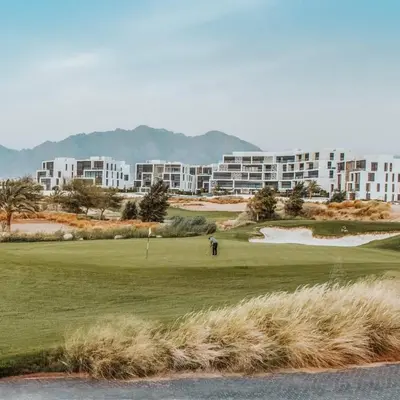 a golfer on a green in front of a building at Ayla and chill Restricted to families and couples only in Aqaba