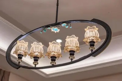 a chandelier hanging from a ceiling with a mirror at Adam's Luxury Villa DeadSea in Sowayma
