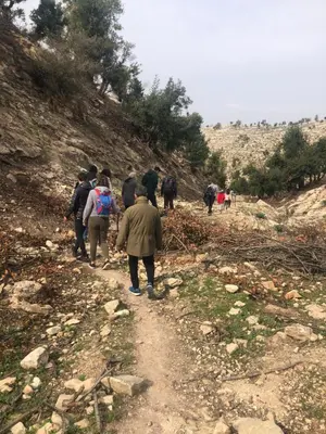 a group of people walking down a dirt trail at Pasha's house in Balad al Manşūrah