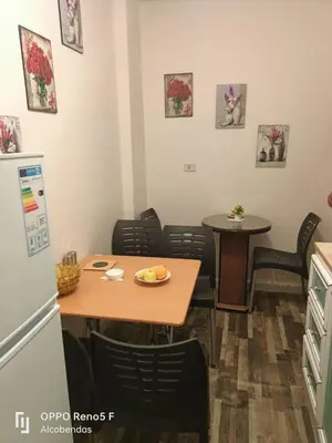 a kitchen with a table and chairs and a refrigerator at Plaza de petra in Wadi Musa