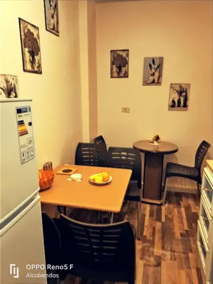 a kitchen with a table and a table and a refrigerator at Plaza de petra in Wadi Musa