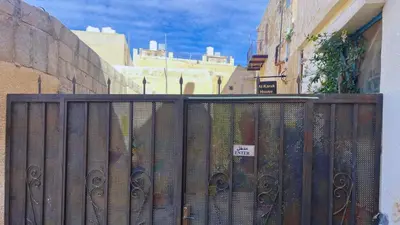 a fence with a bunch of books behind it at Al Karak House in Kerak